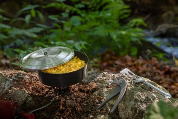 Deep Alpine with NOLS Lid mac 'n cheese on stove with PotGripz and Rada serverspoon/spatula